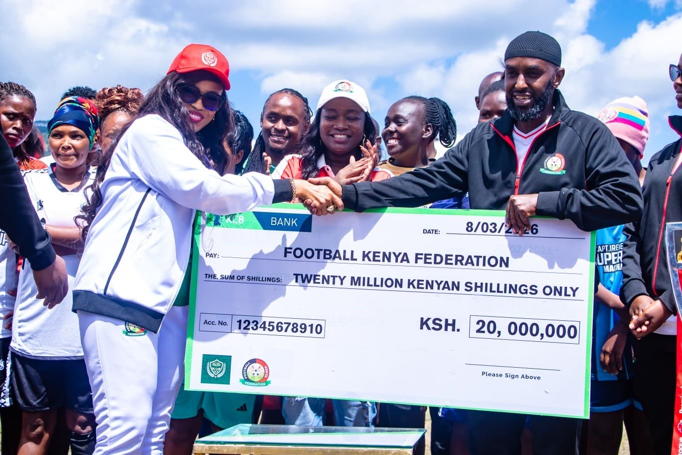 Captain Irene Ndanu holding the Soccer Summit cheque